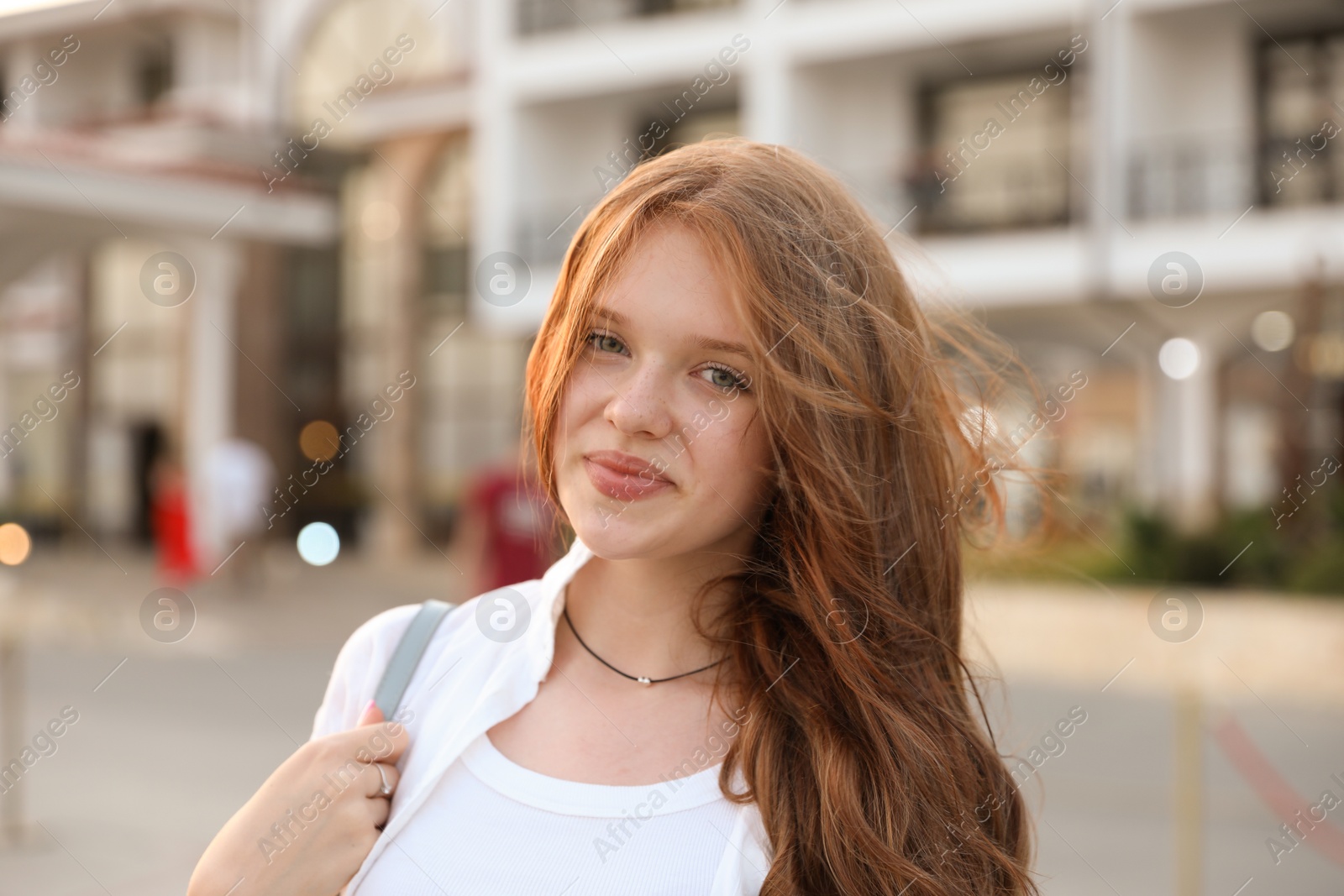 Photo of Portrait of beautiful girl near hotel outdoors