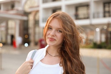 Photo of Portrait of beautiful girl near hotel outdoors
