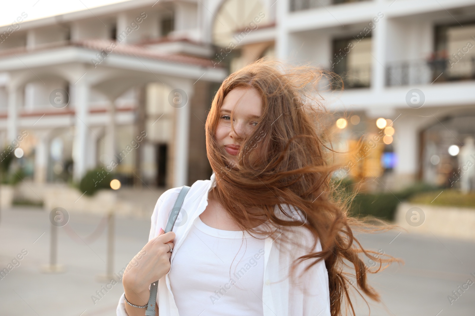 Photo of Portrait of beautiful girl near hotel outdoors