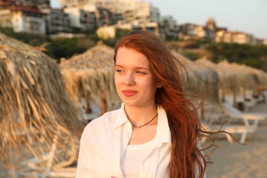 Photo of Portrait of beautiful teenage girl on beach