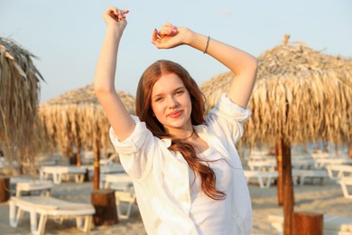 Photo of Portrait of beautiful teenage girl on beach