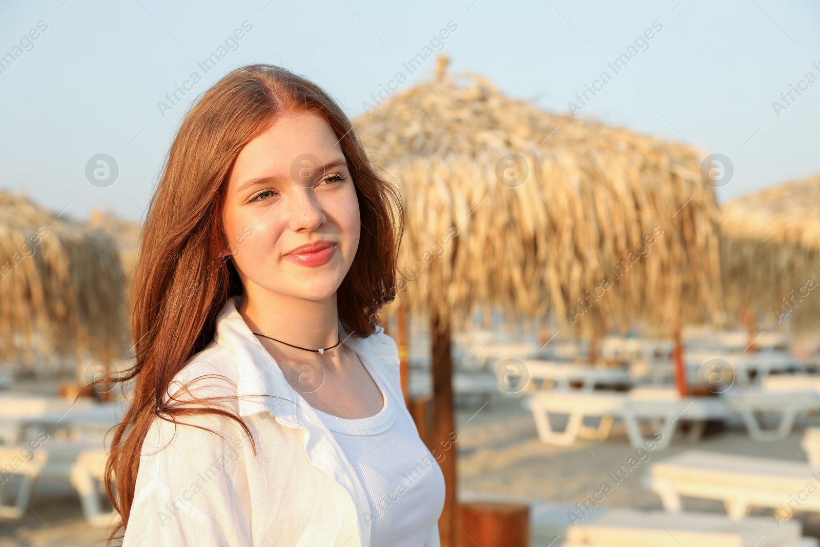 Photo of Portrait of beautiful teenage girl on beach, space for text