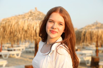 Photo of Portrait of beautiful teenage girl on beach