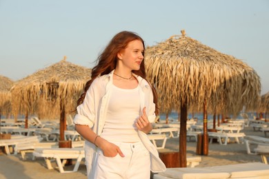 Photo of Portrait of beautiful teenage girl on beach