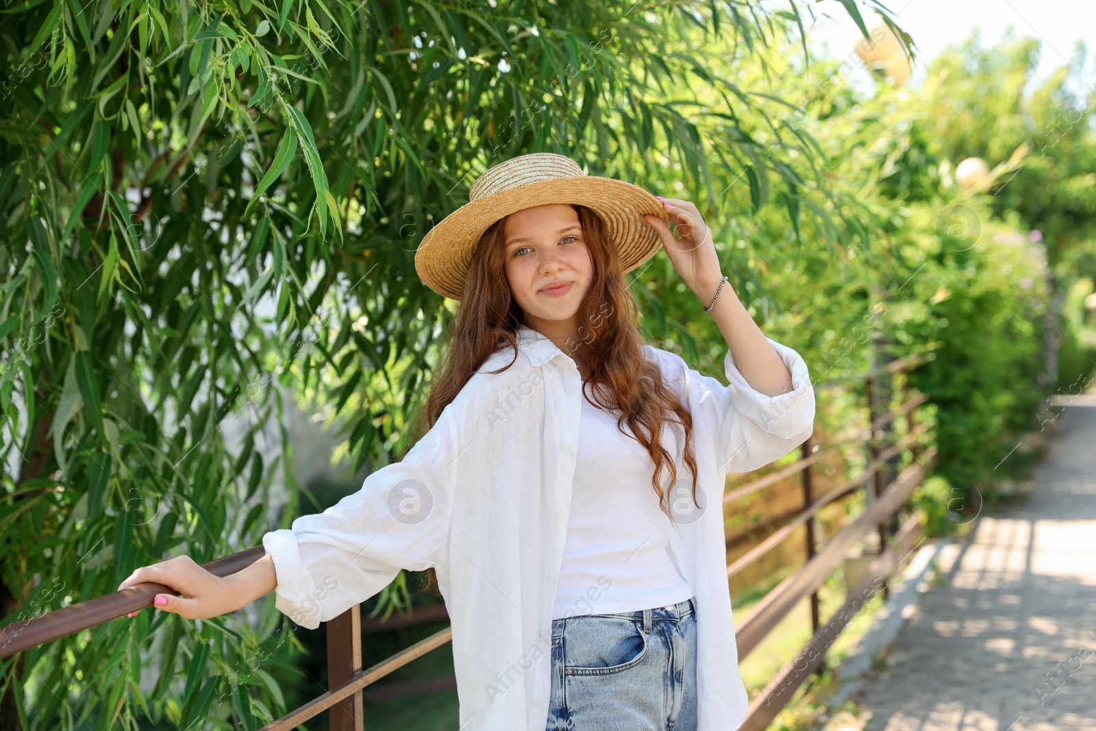 Beautiful girl in straw hat outdoors on sunny day Photo of Beautiful girl in straw hat outdoors on sunny day