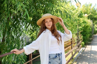 Photo of Beautiful girl in straw hat outdoors on sunny day