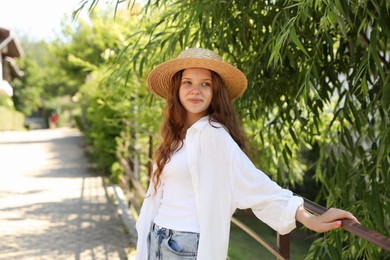 Photo of Beautiful girl in straw hat outdoors on sunny day