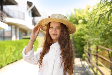 Photo of Beautiful girl in straw hat outdoors on sunny day