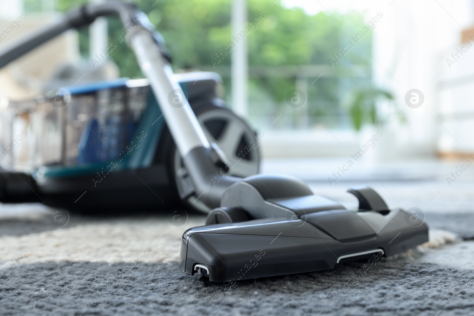 One vacuum cleaner on floor indoors, closeup. Household appliance Photo of One vacuum cleaner on floor indoors, closeup. Household appliance