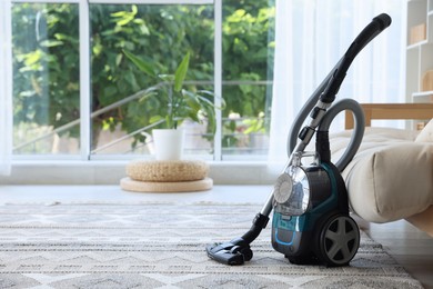 Photo of One vacuum cleaner on floor indoors. Space for text