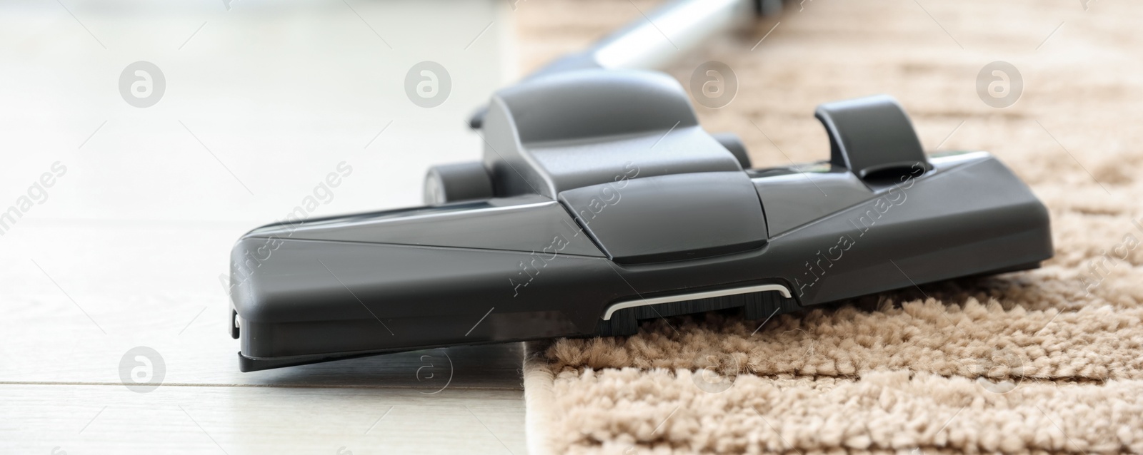 One vacuum cleaner on floor indoors, closeup Photo of One vacuum cleaner on floor indoors, closeup