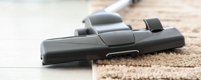 Photo of One vacuum cleaner on floor indoors, closeup