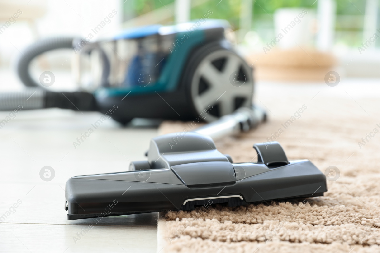 One vacuum cleaner on floor indoors, closeup Photo of One vacuum cleaner on floor indoors, closeup