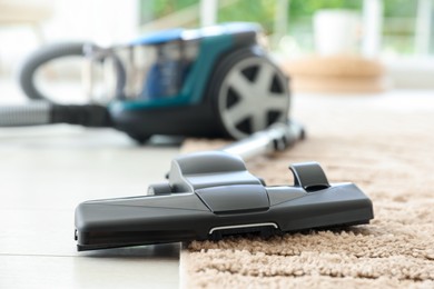 Photo of One vacuum cleaner on floor indoors, closeup