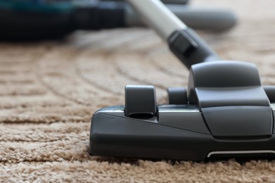 Photo of One vacuum cleaner on floor indoors, closeup