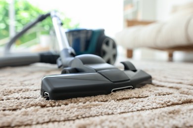 Photo of One vacuum cleaner on floor indoors, closeup