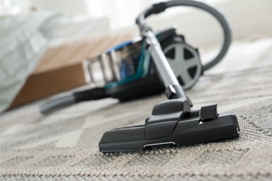 Photo of One vacuum cleaner on floor indoors, closeup