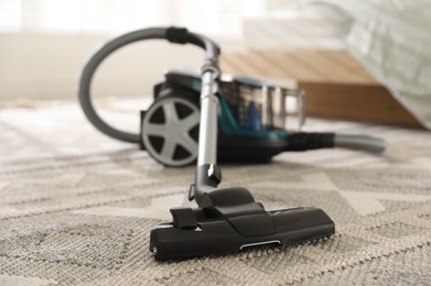 Photo of One vacuum cleaner on floor indoors, closeup
