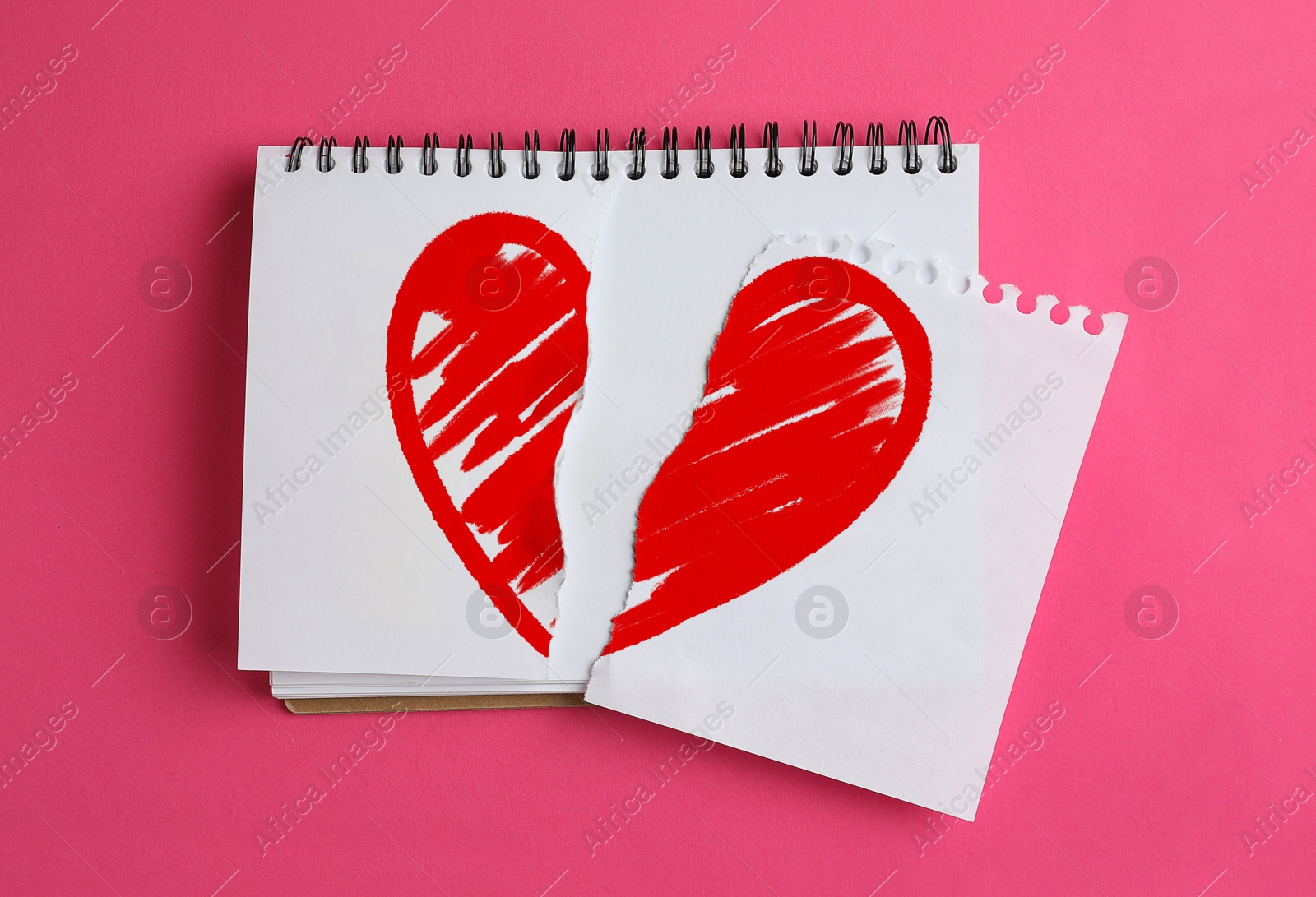 Betrayal. Torn notebook paper with red heart on pink background, top view Image of Betrayal. Torn notebook paper with red heart on pink background, top view