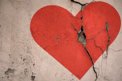 Image of Betrayal. Red heart on cracked old wall