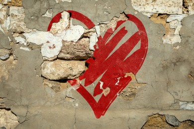 Image of Betrayal. Red heart on cracked old wall
