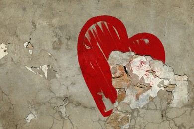 Image of Betrayal. Red heart on cracked old wall