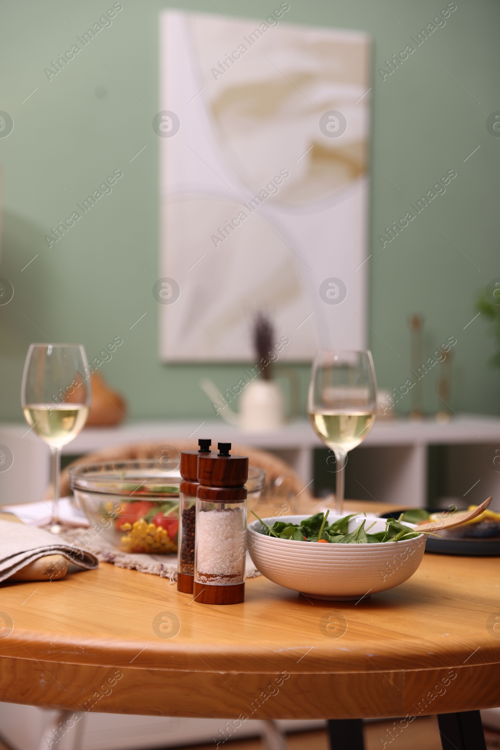 Dinner table with tasty food and white wine indoors Photo of Dinner table with tasty food and white wine indoors