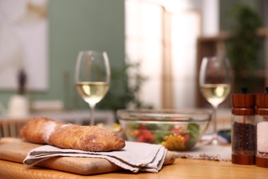 Photo of Tasty food and white wine on wooden table indoors, closeup