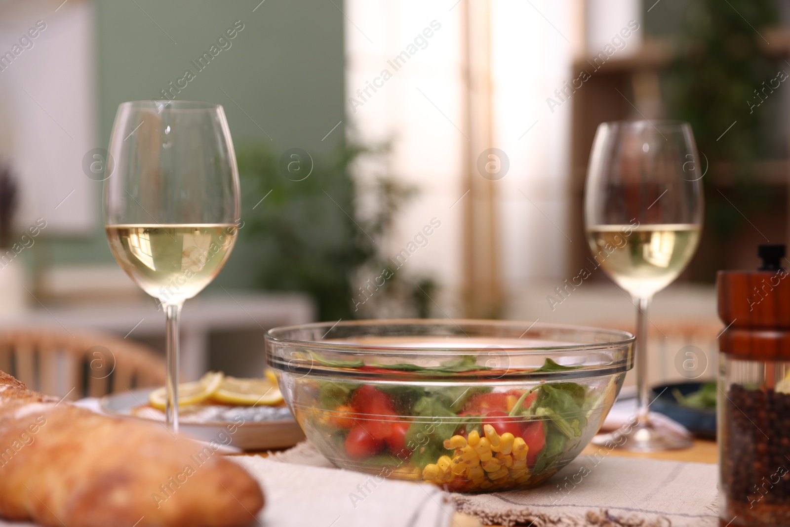 Tasty food and white wine on table indoors, closeup Photo of Tasty food and white wine on table indoors, closeup