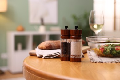 Photo of Tasty food and white wine on wooden table indoors, closeup