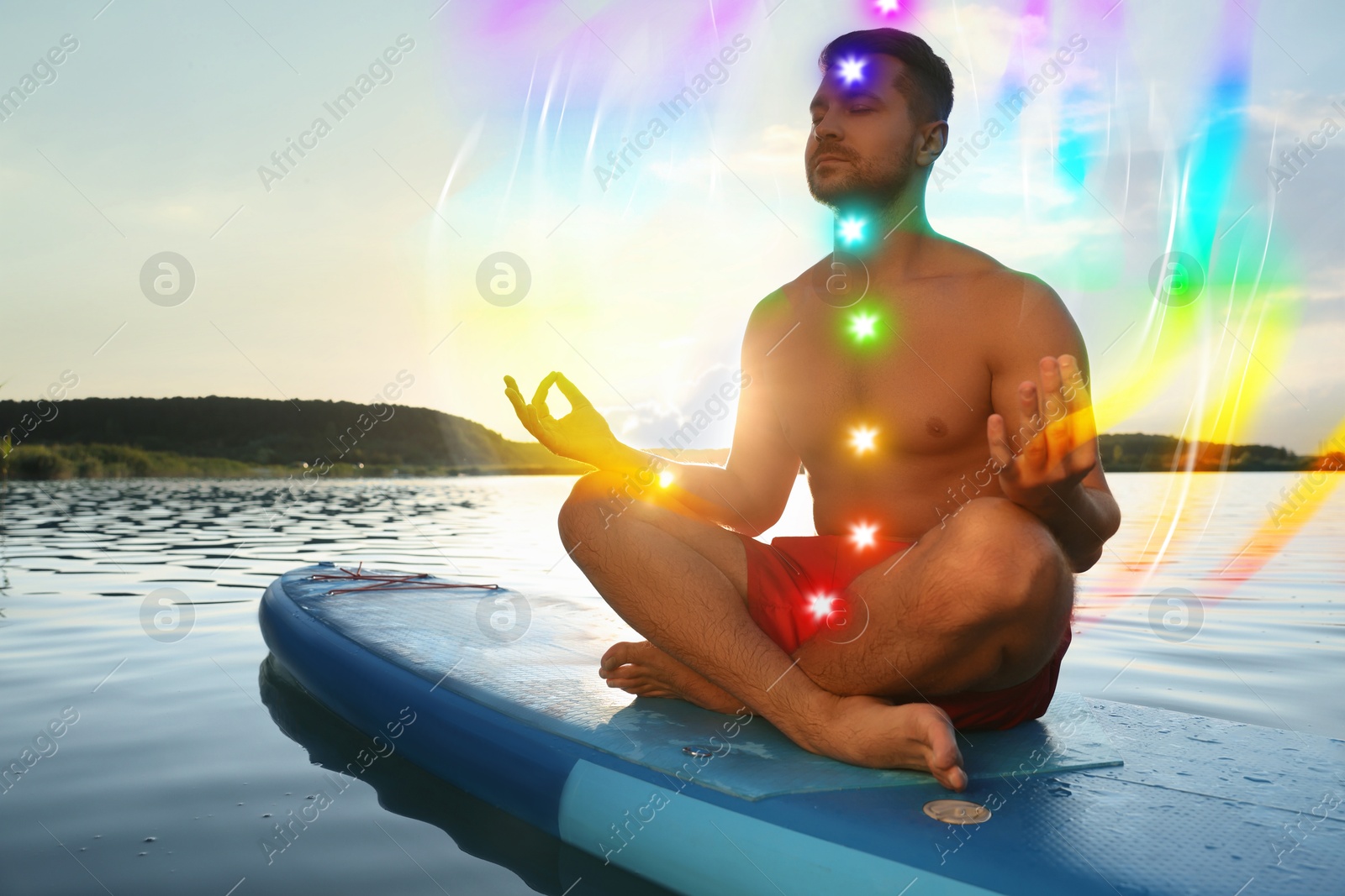 Man meditating in Lotus pose on SUP board. Aura seen as rainbow waves around him. Seven chakras glowing Image of Man meditating in Lotus pose on SUP board. Aura seen as rainbow waves around him. Seven chakras glowing