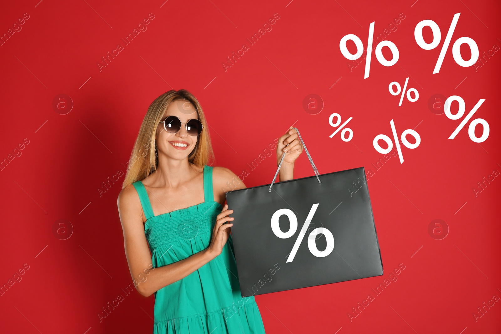 Happy woman holding shopping bag with percent sign on red background. Special offer, hot sale Image of Happy woman holding shopping bag with percent sign on red background. Special offer, hot sale