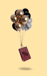 Image of Hot sale, special offer. Shopping bag and balloons with percent signs in air against beige background