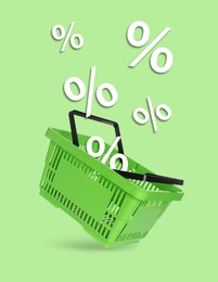 Image of Hot sale, special offer. Percent signs flying out of shopping basket against light green background