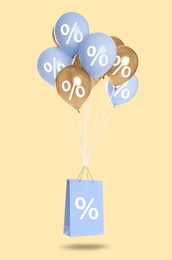 Image of Hot sale, special offer. Shopping bag and balloons with percent signs in air against beige background