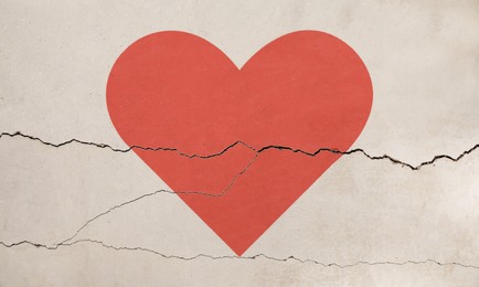 Image of Betrayal. Red heart on cracked old wall