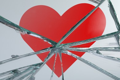Image of Betrayal. Broken glass with red heart, top view