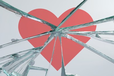 Image of Betrayal. Broken glass with red heart, closeup