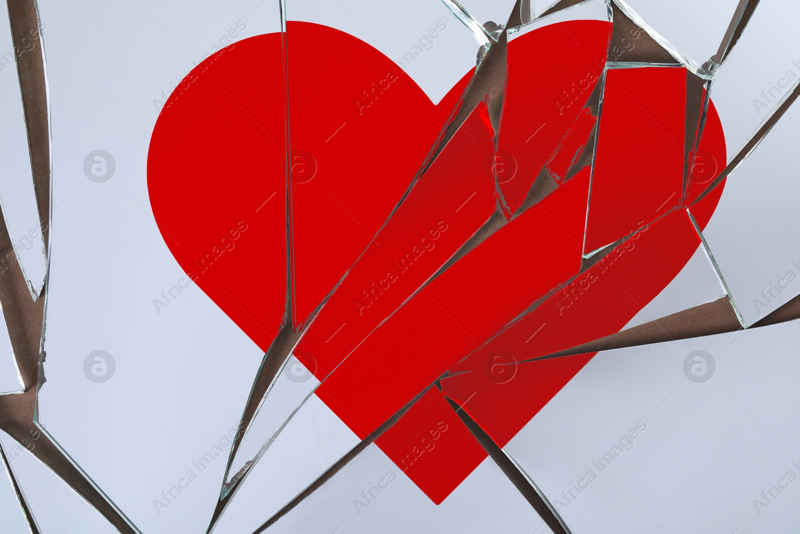 Betrayal. Broken glass with red heart, top view Image of Betrayal. Broken glass with red heart, top view