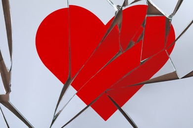 Image of Betrayal. Broken glass with red heart, top view