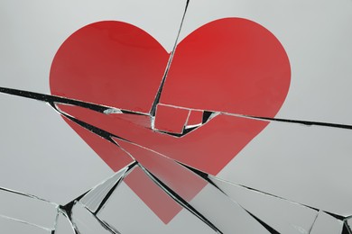 Image of Betrayal. Broken glass with red heart, top view