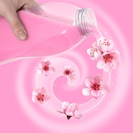 Image of Fabric softener advertising poster. Woman pouring conditioner against pink background. Flowers floating along stream of liquid