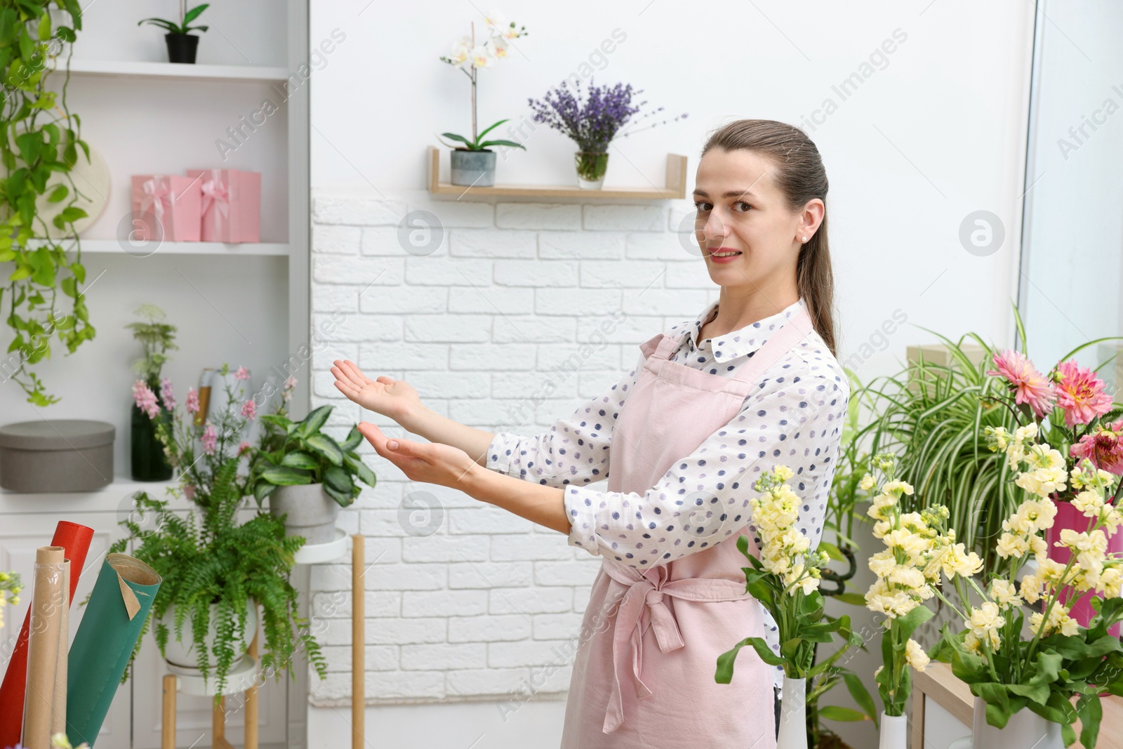 Portrait of professional florist with flowers in shop Photo of Portrait of professional florist with flowers in shop
