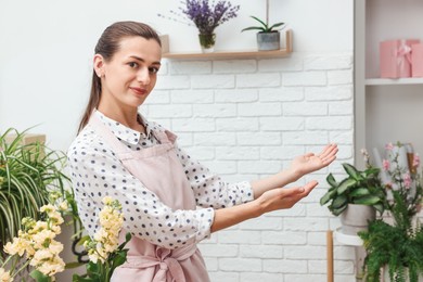 Photo of Portrait of professional florist with flowers in shop
