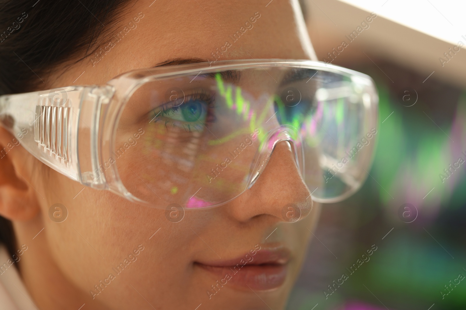 Young woman wearing glasses with reflection on blurred background, closeup Photo of Young woman wearing glasses with reflection on blurred background, closeup
