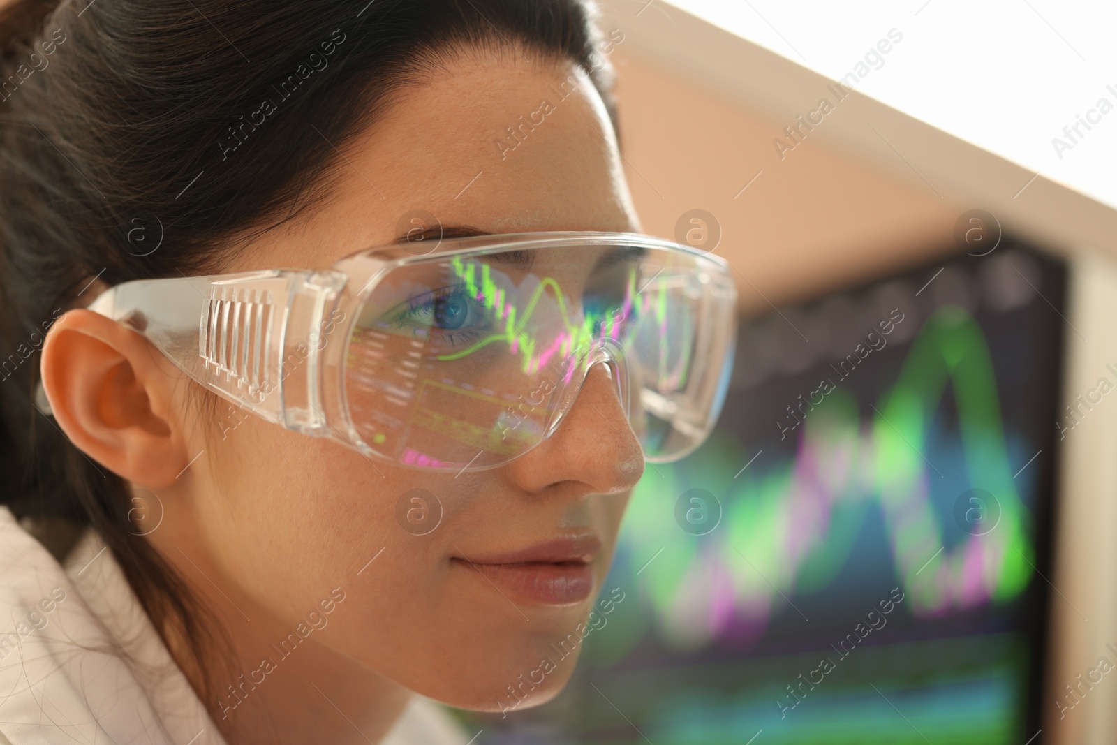 Young woman wearing glasses with reflection on blurred background, closeup Photo of Young woman wearing glasses with reflection on blurred background, closeup