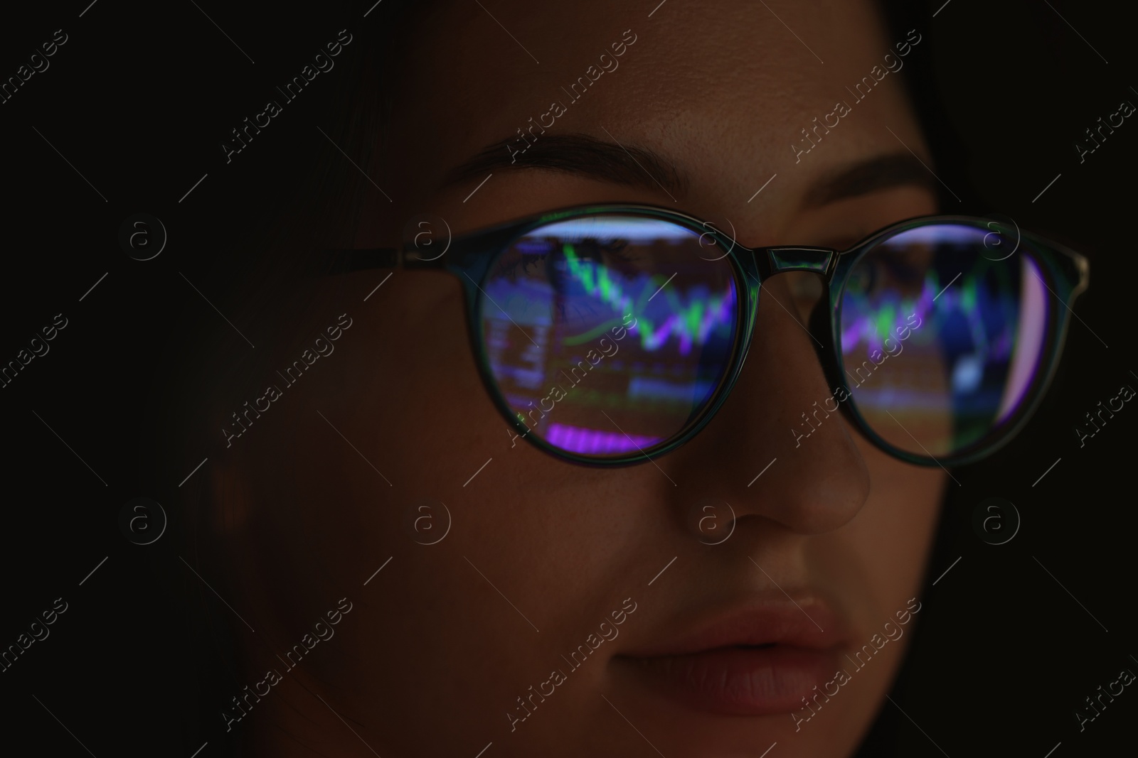 Young woman wearing glasses with reflection on dark background, closeup Photo of Young woman wearing glasses with reflection on dark background, closeup