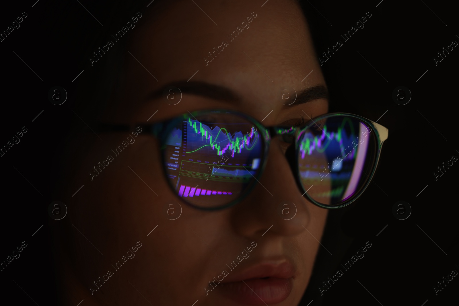 Young woman wearing glasses with reflection on dark background, closeup Photo of Young woman wearing glasses with reflection on dark background, closeup