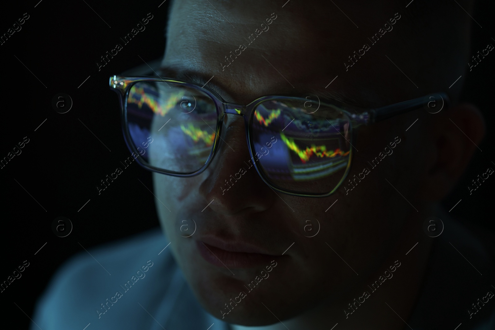 Young man wearing glasses with reflection on dark background, closeup Photo of Young man wearing glasses with reflection on dark background, closeup