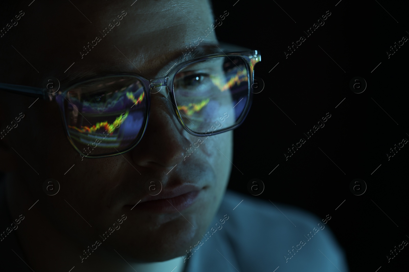 Young man wearing glasses with reflection on dark background, closeup Photo of Young man wearing glasses with reflection on dark background, closeup